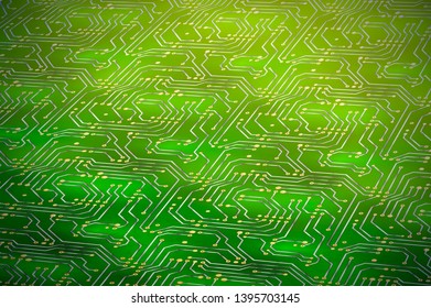 Complicated computer microchip with golden contacts on green motherboard in perspective