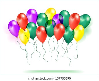 Composition of balloons purple, red, green and yellow on a green background.
