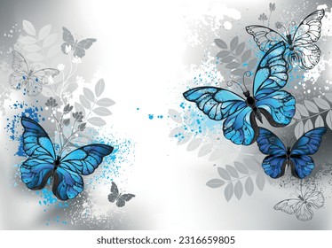 Composition of detailed blue morpho butterflies, decorated with blue paint drops with silhouette wild plants on gray background.