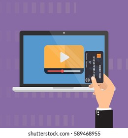 Computer laptop with video playing and business man with credit card for paying. Video Marketing business concept.