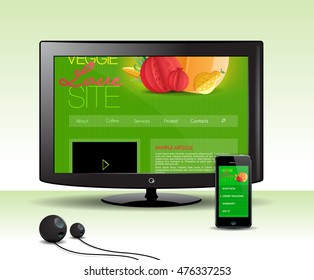 Computer LCD monitor and a smartphone with responsive design site on the screen.