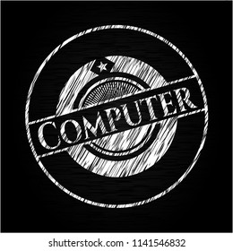 Computer on chalkboard