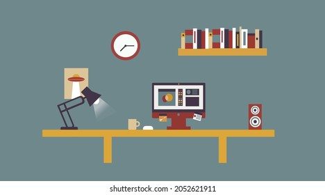 Computer on a table with books and light