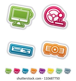 Computer parts and accessories, pictured here from left to right:  All-in-one computer, Game Steering wheel, Multimedia card reader, Projector.