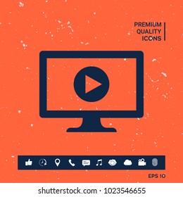 Computer with play button icon