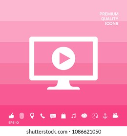 Computer with play button icon