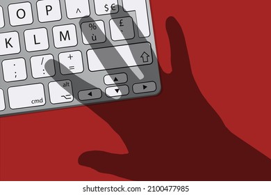 Computer security and data breach risk concept with shadow symbol of a hand threatening a computer keyboard.