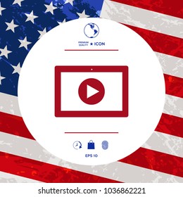 Computer tablet with play button icon