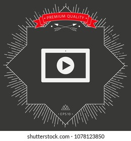 Computer tablet with play button icon