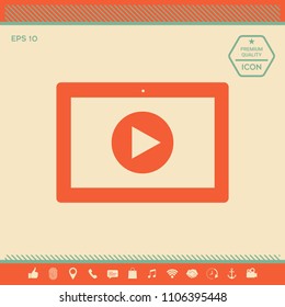 Computer tablet with play button icon