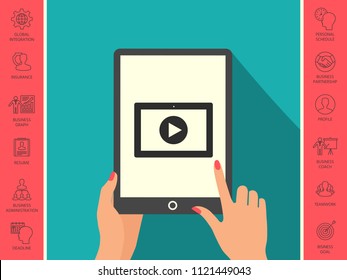 Computer tablet with play button icon