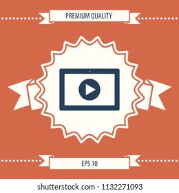 Computer tablet with play button icon