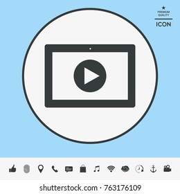 Computer tablet with play button icon