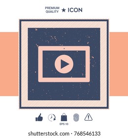 Computer tablet with play button icon