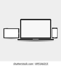 Computers and a mobile phone on a gray background