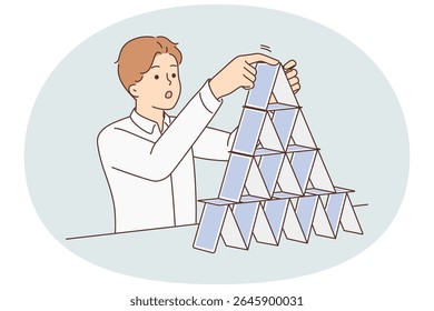 Concentrated man makes pyramid of playing cards symbolizing fragile business structure and unsustainable strategy for development of company. Concept construction of financial pyramids blaming fraud