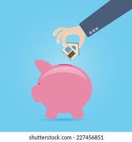 Concept About Savings For House Purchase. Hand Throwing The Small Icon Of Home In The Piggy Bank.