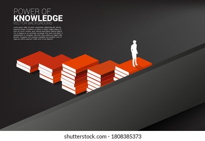 Concept background for power of knowledge. Silhouette of businessman move to cross wall with step from book stack.