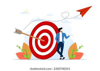 concept of business goal, aim or target, intent and resolution to achieve success, aspiration and motivation to achieve goal, confident businessman standing with arrow on target at archery target.