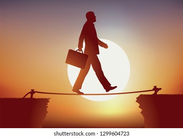Concept of a businessman sure of himself, who crosses an obstacle while crossing a precipice, balancing on a rope like a tightrope walker