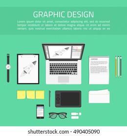 Concept of creative office workspace. Working place of designer with devices for work. Top view of desk background with laptop, graphic tablet digital devices, office objects and documents. 