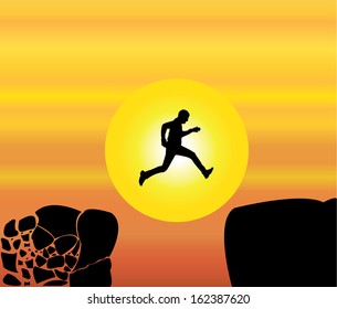 Concept design vector illustration art of young fit man jumping from a crumbing mountain rock to another safer rock on a bright orange morning or evening sky and yellow sun in the background