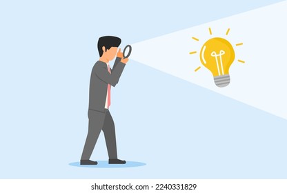 concept of discovering idea. a businessman holding magnifying glass to find a bright lamp. looking for an idea