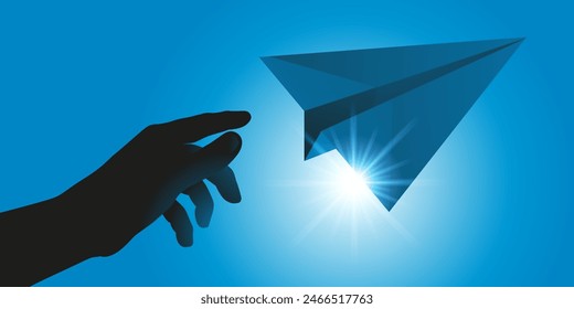 Concept of dreams and freedom with a hand throwing a paper plane into a blue sky.