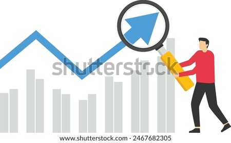 Concept of economic growth with chart and magnifying glass

