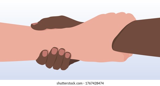 Concept of the fight against racism with two people of different races who hold each other’s arms as a sign of brotherhood.