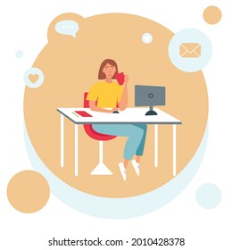 The concept of freelancing, working at home. A woman is sitting at a table in front of a computer and drinking a drink from a cup.