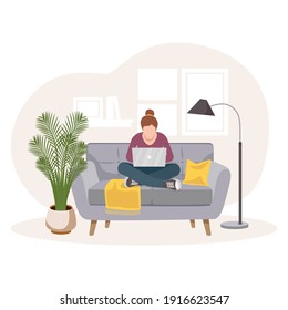 The concept of home office. Self-isolation during the coronavirus epidemic. A woman working from home, distance learning sitting on the couch, the concept of remote work. Freelancer. Interior of room.