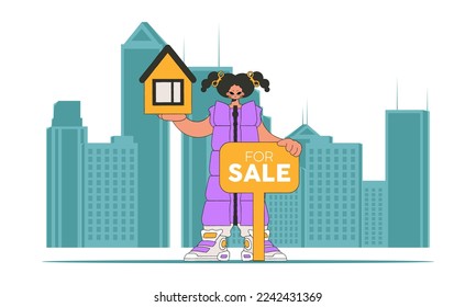 The concept of home ownership. An attractive realtor girl is holding a house.