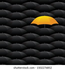 Concept of individuality and difference. Yellow umbrella among many dark ones. Standing out from crowd