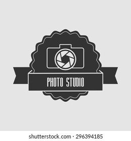 Concept logo photo studio. The camera lens and with the words "Photo Studio" on the tape. Can be used to design business cards, posters, posters; decorating shop windows and signage