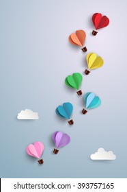 concept of love and valentine day, origami made hot air balloon in a heart shape flying on blue sky. paper art style.