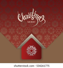 Concept for luxury holiday card. Lettering "Merry Christmas" on red patterned background with snowflakes. Stylized small house with on cardboard.