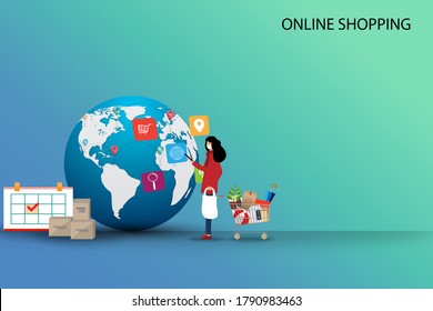 Concept of online shopping, young woman is standing near supermarket basket and hold a smartphone to order the goods from the application in a background of globe and route of the shipments.