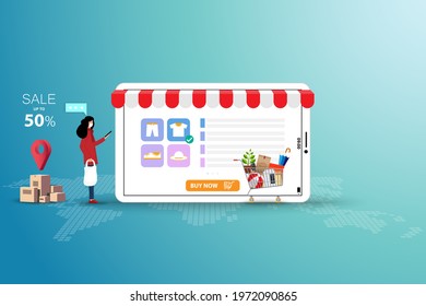 Concept of online shopping, young woman wear a medical white face mask and hold a tablet to order a new shirt that shown on a big screen in green shade color background.