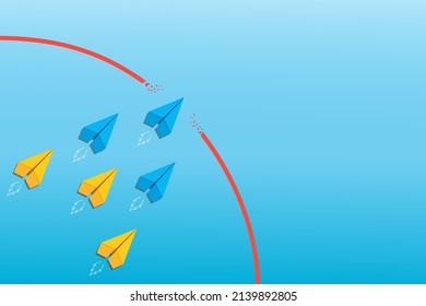 Concept of overcoming barriers on the way to goal with blue, yellow paper plane breaking through obstacle on blue background. Deal with difficulties on the way to target.