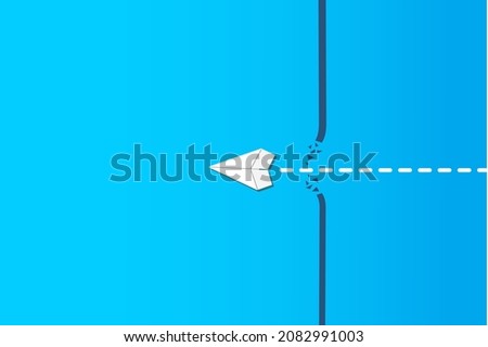 Concept of overcoming barriers on the way to goal, target, with white paper airplane breaking through obstacle on blue background.