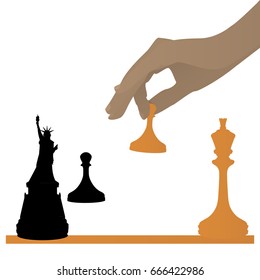 The concept of a political game. USA on the world oren, player's hand from above. Queen is a freedom.