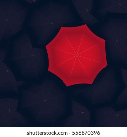 concept of red umbrella standing out of the black