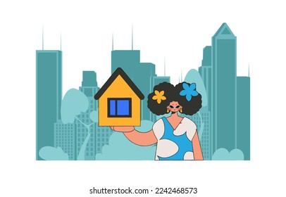 Concept Selling and owning a house. An attractive realtor girl holds a house in her hands.