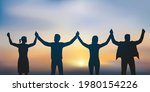 Concept of solidarity and success with four people joining hands in friendship.