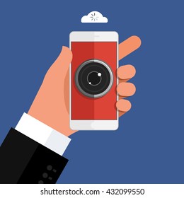 Concept of spying. Hand holding smartphone with camera eye on display. Mobile smart phone in hand on dark background. Flat design, vector illustration