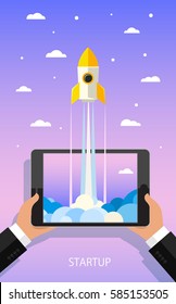 Concept of Start up. Businessman holding a tablet with a rocket. Flat design, vector illustration