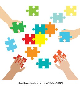 Concept of teamwork and integration with businessman holding colorful puzzle