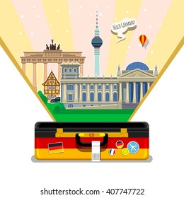 Concept of travel to Germany or studying German. German flag with landmarks in open suitcase. Time to travel. 