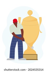 The concept of winning the game of golf. A man with a golf club near the big victory cup